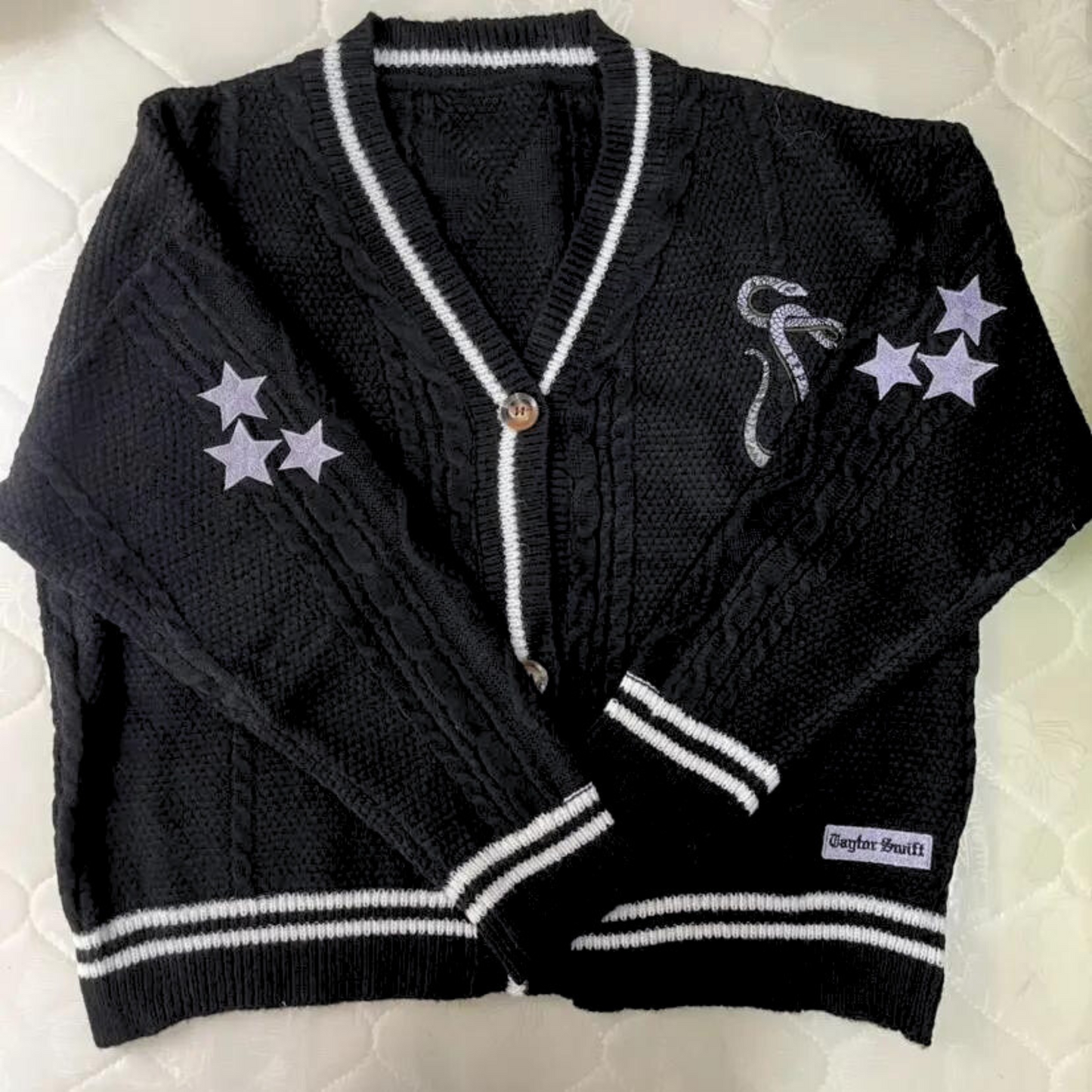 black reputation cardigan featuring the embroidered snake and stars